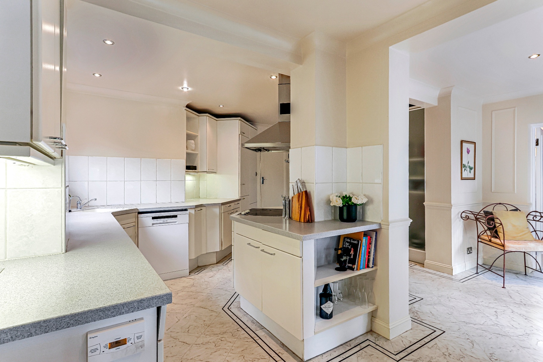 Well-stocked kitchen with central island and open-plan flow