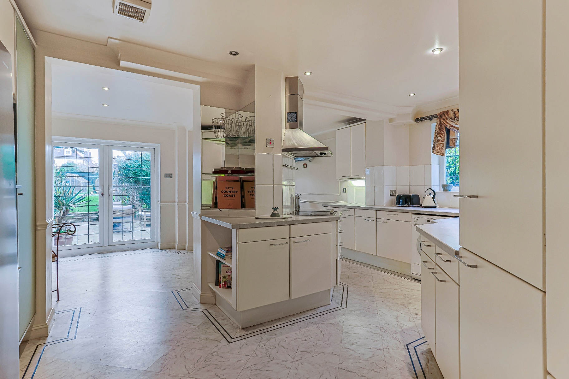 Bright kitchen opening through to the garden doors and patio