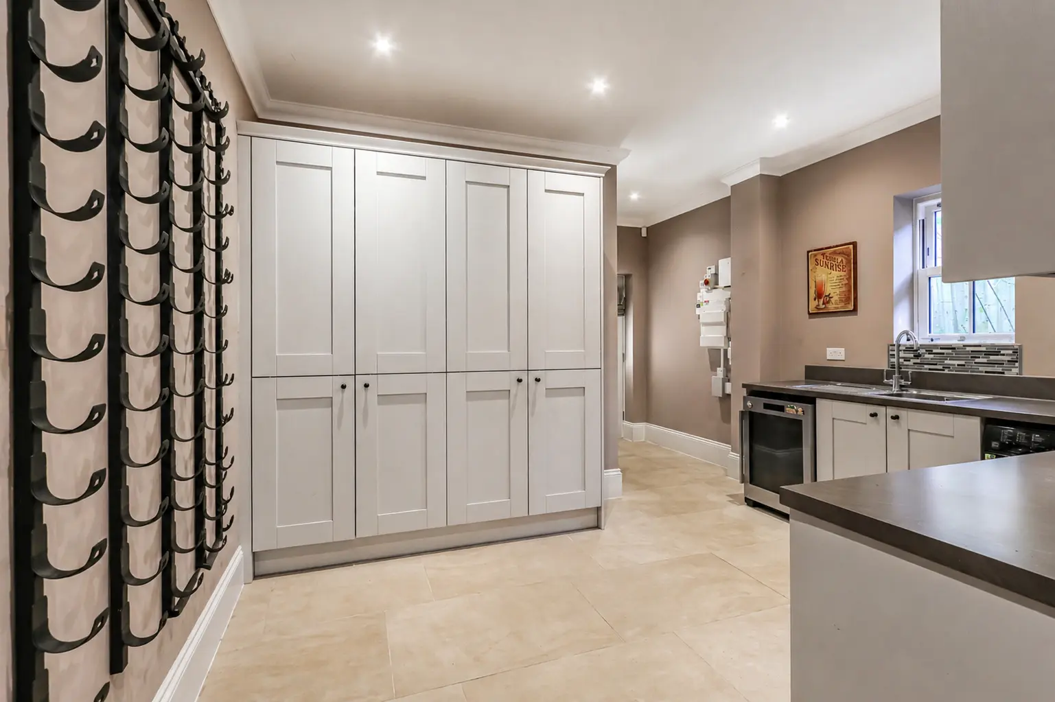 Utility room with wine racking and secondary sink