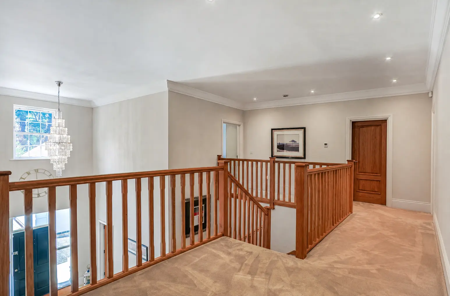 Galleried landing with chandelier above the entrance hall