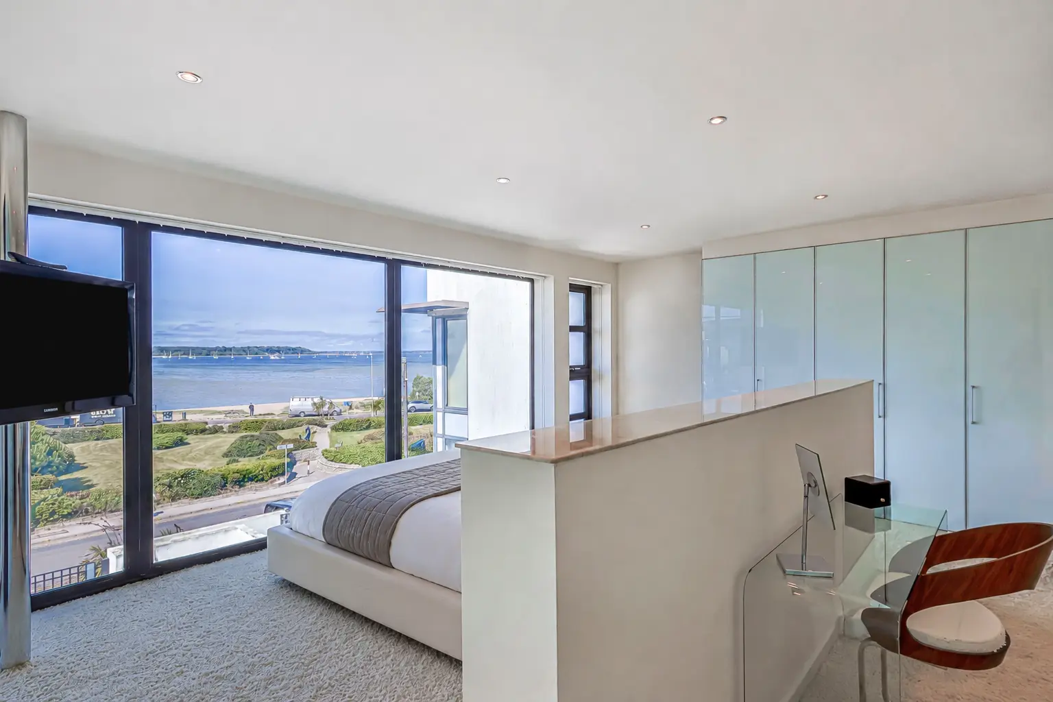 Bedroom with full-height glazing framing Poole Harbour