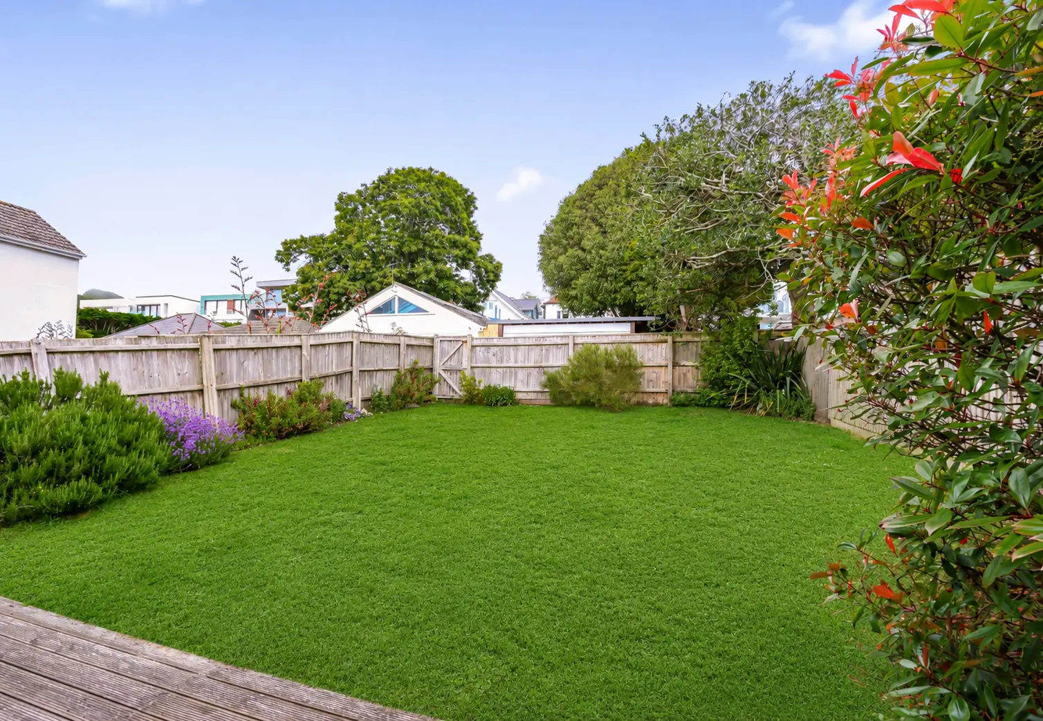 Private rear garden with lawn and decked terrace